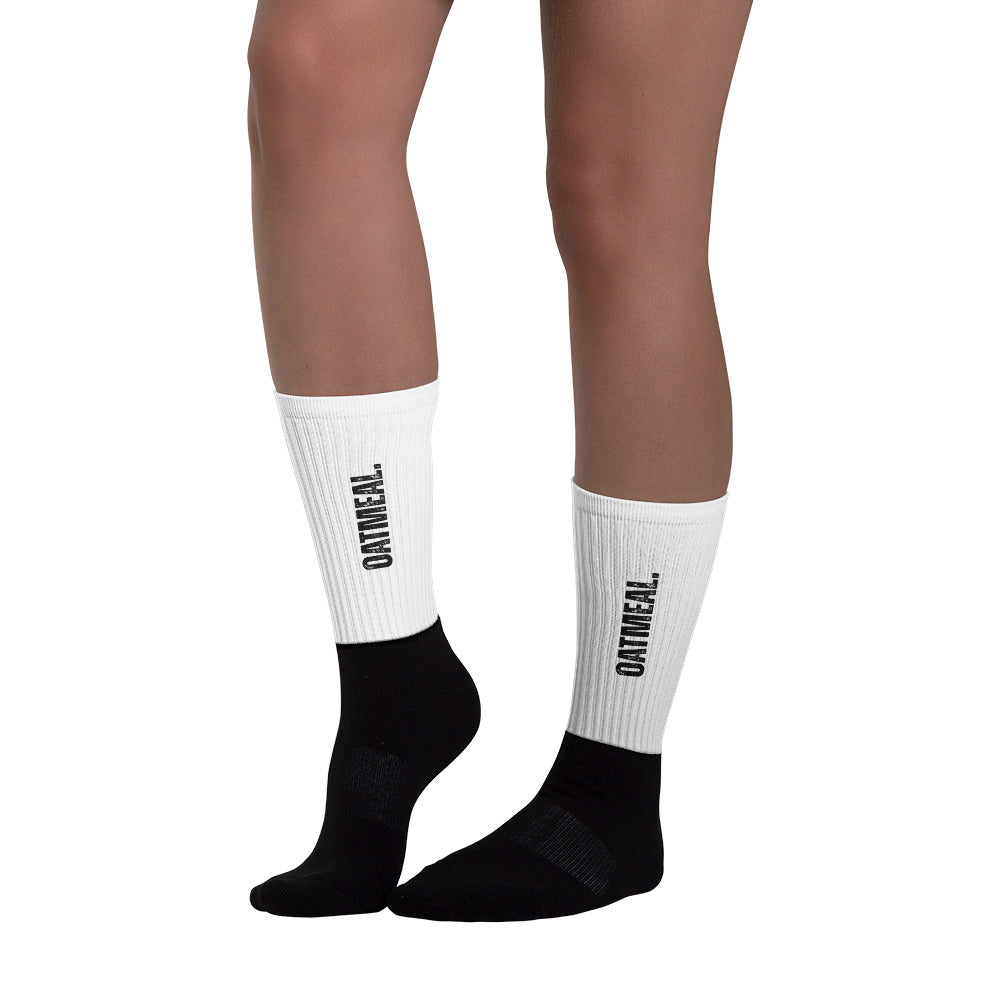 Black and white socks with 'Oatmeal' branding on a white background at Oatmeal Apparel Co.