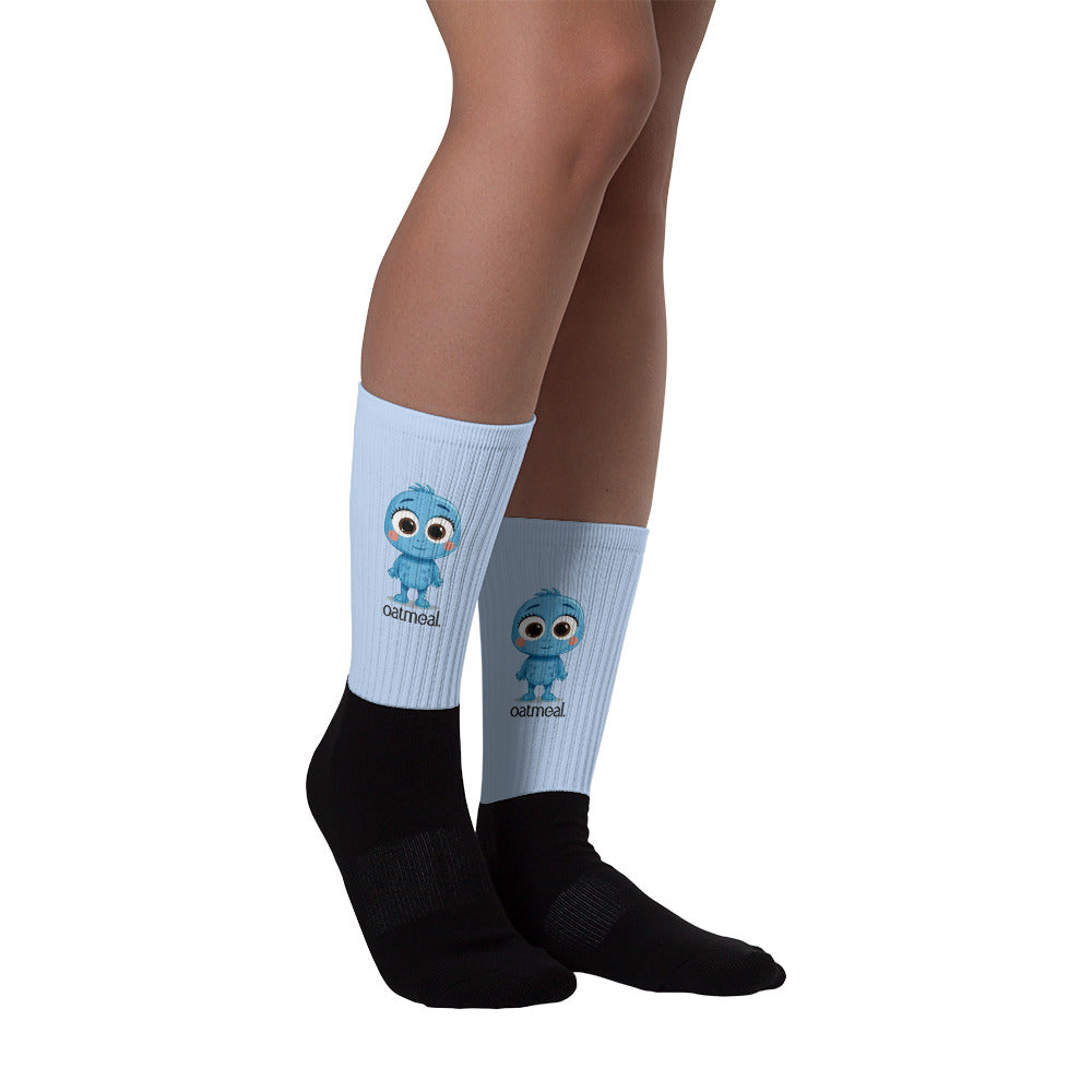 Person wearing light blue socks with a Oatmeal cartoon character and black socks at Oatmeal Apparel Co.