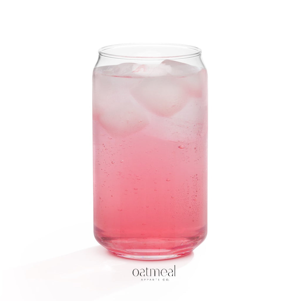 Clear glass with pink liquid and ice cubes on a white background, featuring 'oatmeal' branding at Oatmeal Apparel Co.