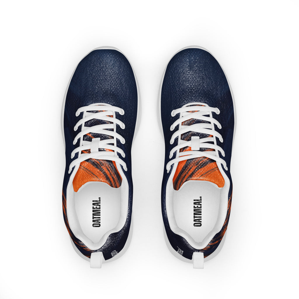 Pair of navy blue sneakers with orange accents on a white background at Oatmeal Apparel Co.