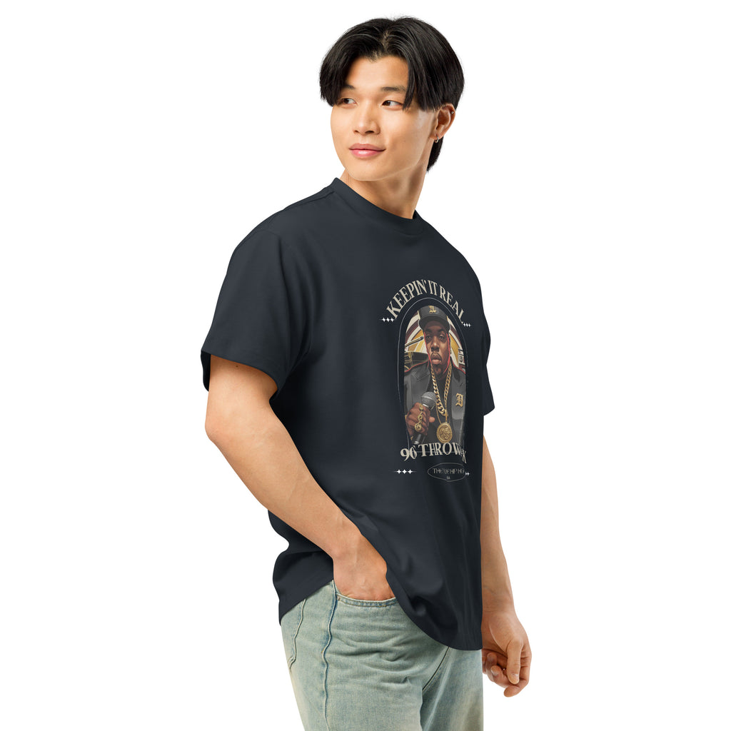 Person wearing a black t-shirt with a 'Keepin' it Real' graphic design on front, shirt available at Oatmeal Apparel Co.