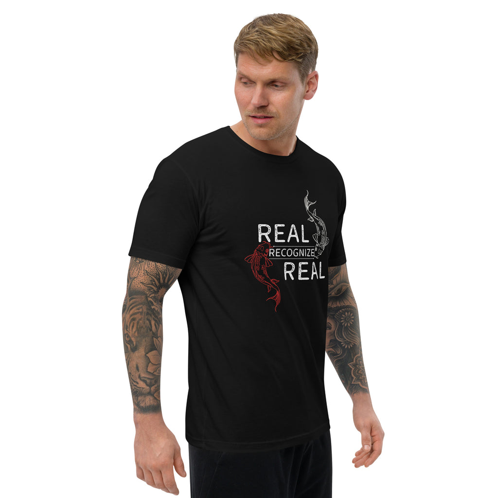 Man wearing a black t-shirt with 'Real Recognize Real' design on a white background at Oatmeal Apparel Co.