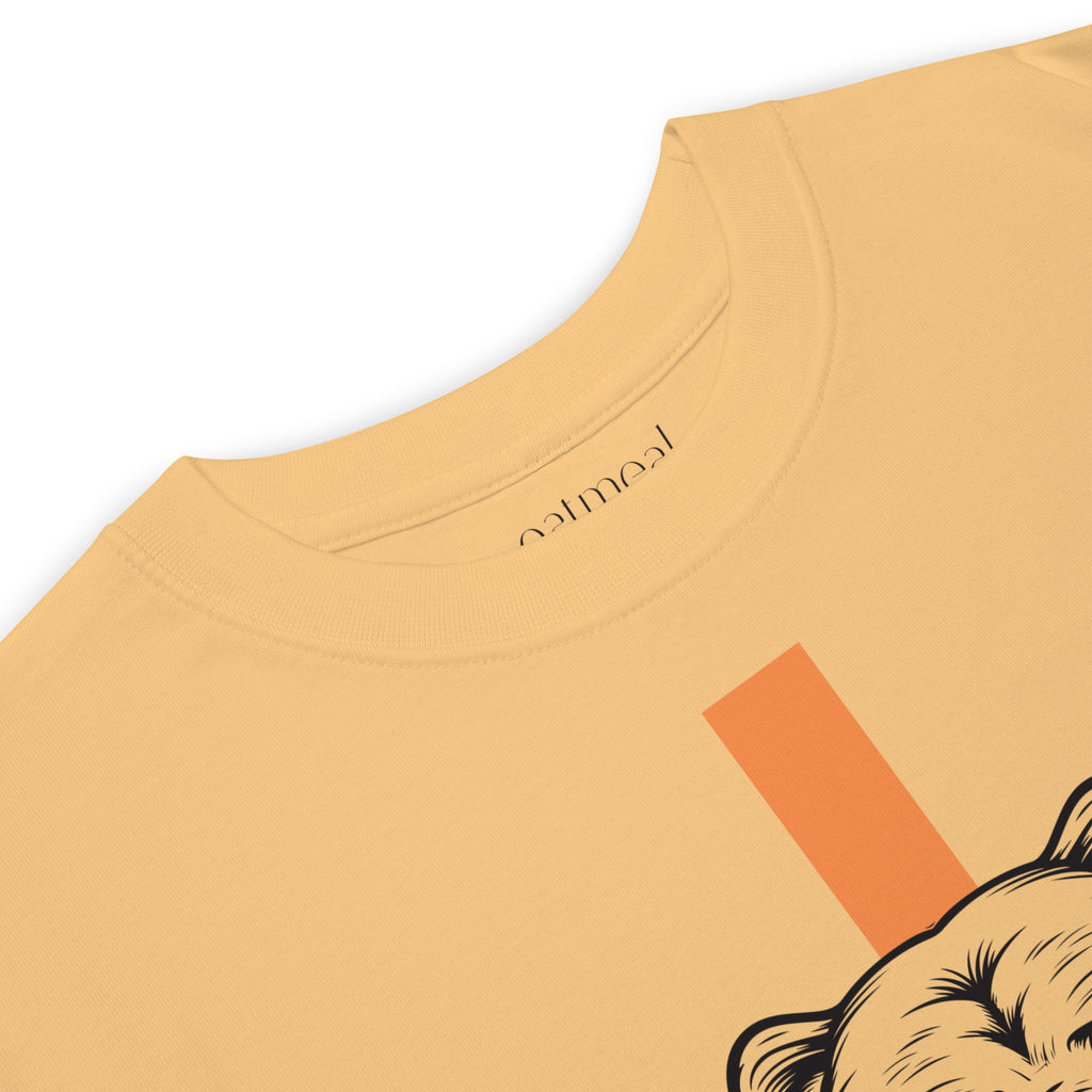 Close-up of a mustard yellow t-shirt with a graphic bear design with 'oatmeal' branding on a white background at Oatmeal Apparel Co.
