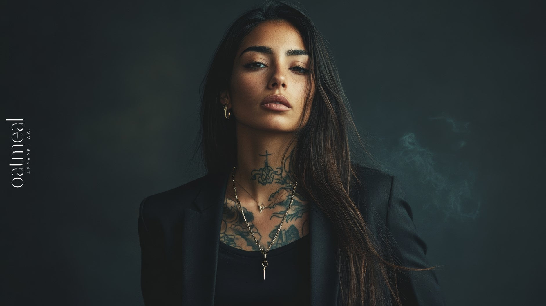 Woman with tattoos wearing a black outfit against a dark background at Oatmeal Apparel Co., STAY TRUE unapologetic collection.