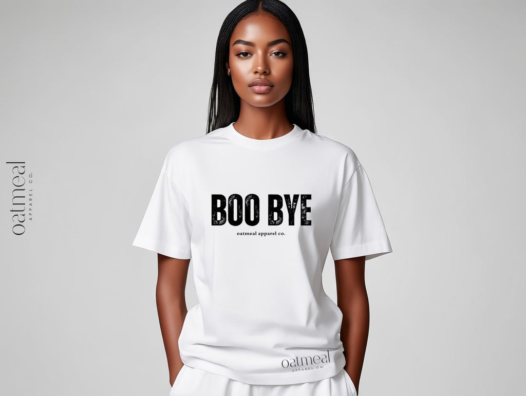 Person wearing a white t-shirt with 'BOO BYE' text on a gray background with 'oatmeal apparel co.' branding