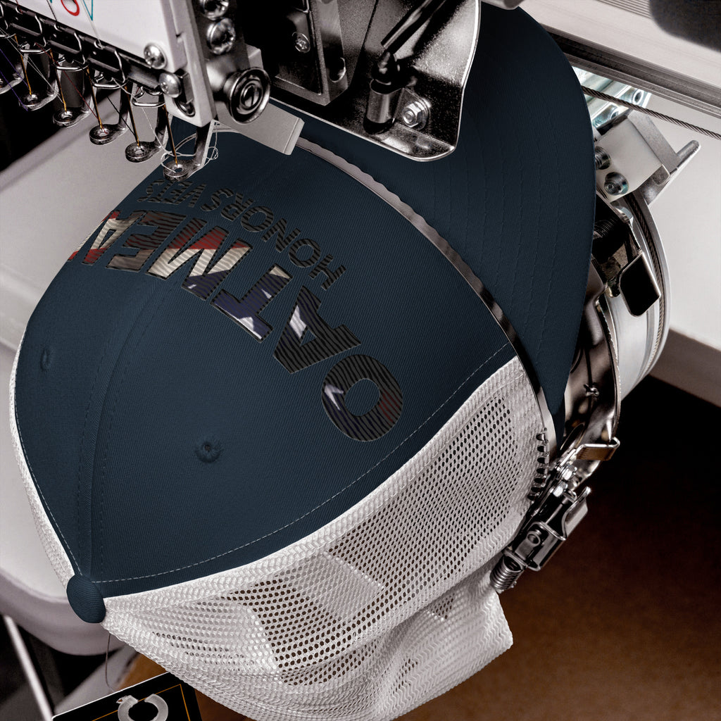 Embroidery machine with a cap being embroidered on a wooden surface at Oatmeal Apparel Co.