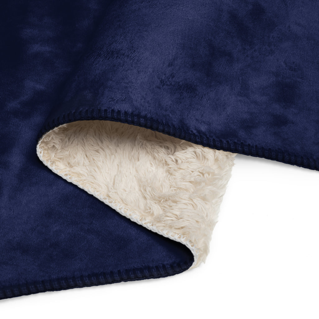 Navy blue fleece blanket with beige sherpa lining on a white background at Oatmeal Apparel Co.