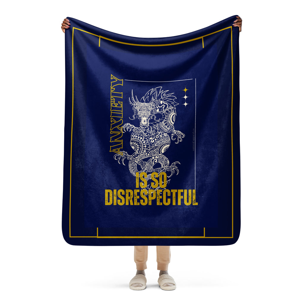 Person holding a navy blue blanket with a dragon design and text on a white background at Oatmeal Apparel Co.