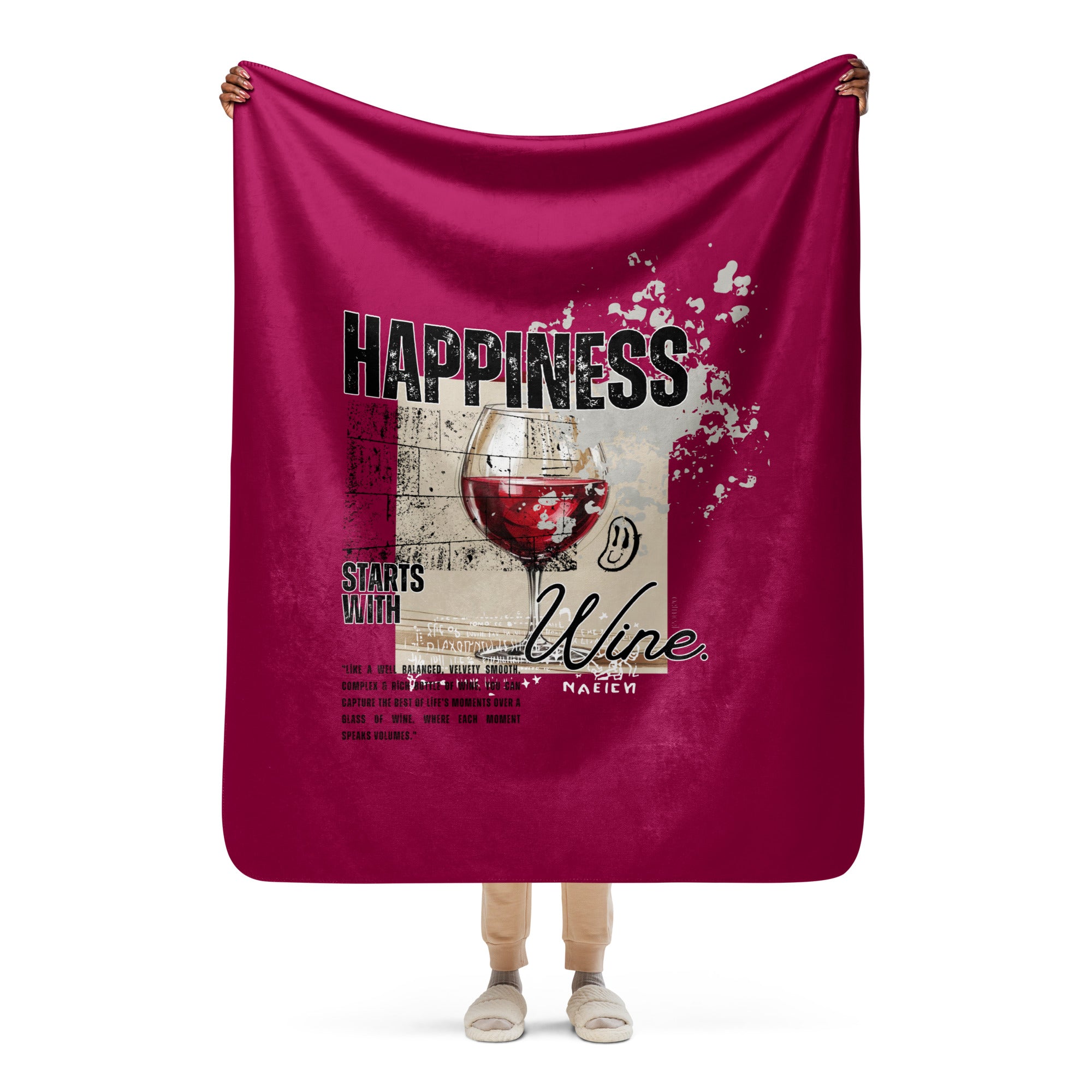 Person holding a magenta blanket with a wine-themed design and text at Oatmeal Apparel Co.