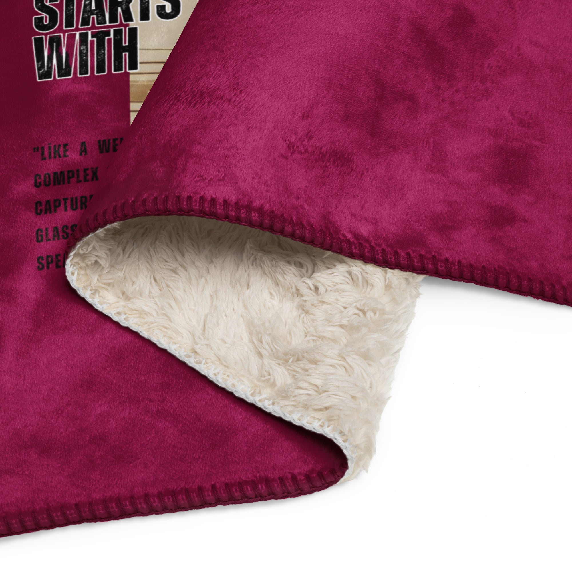 Close-up of a maroon blanket with a beige fleece lining on a white background at Oatmeal Apparel Co.
