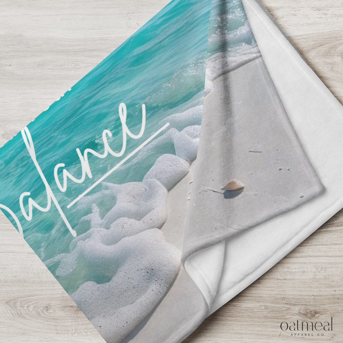 Blanket with 'Find Your Balance' text on a beach-themed design at Oatmeal Apparel Co.