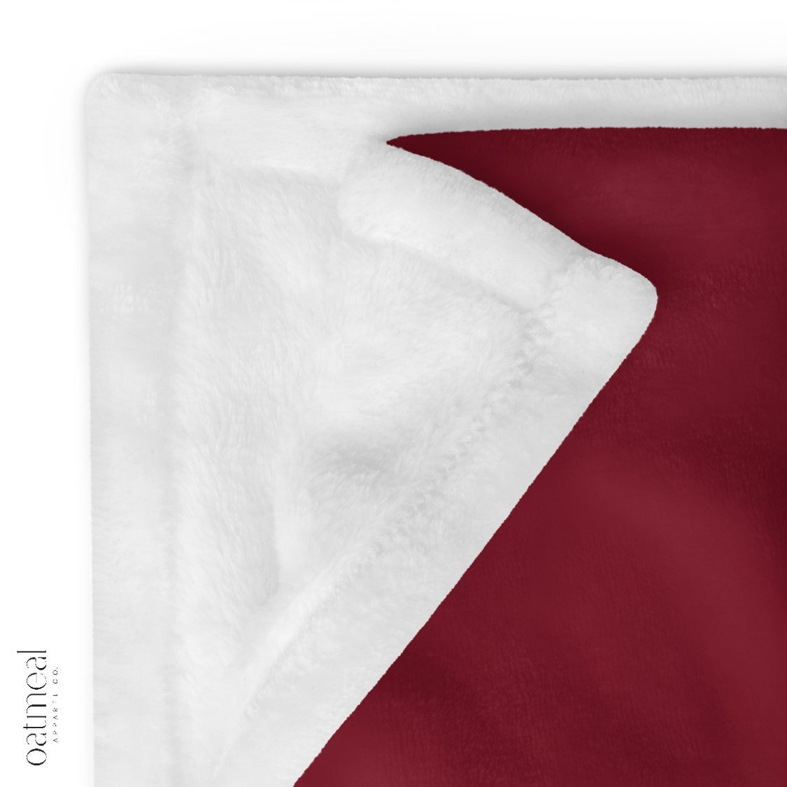 Close-up of a red and white soft plush fabric texture blanket at Oatmeal Apparel Co.