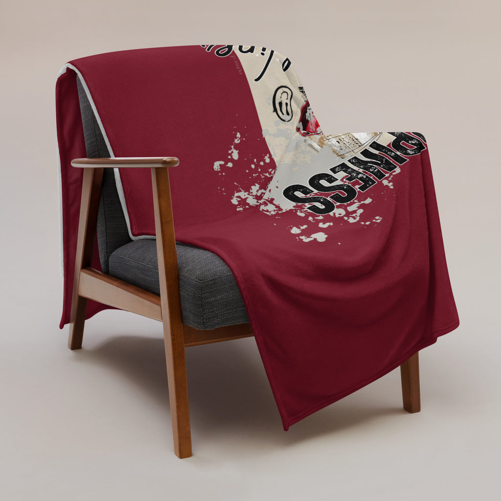 Throw Blanket draped over a chair with a 'happiness and wine' custom graphic design exclusively at Oatmeal Apparel Co.
