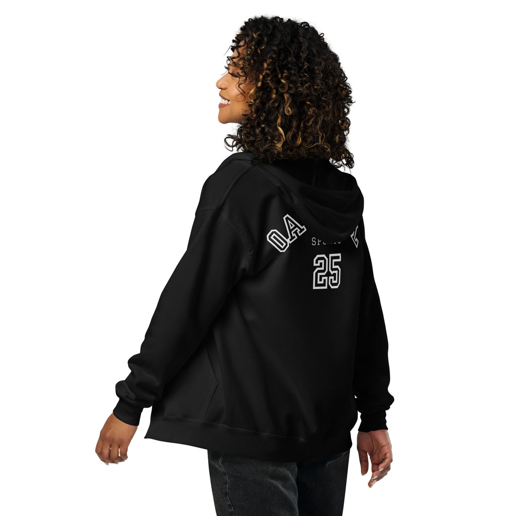 Person wearing a black hoodie with 'Oatmeal Sports No.25' text on the back, standing against a white background exclusively available at Oatmeal Apparel Co.