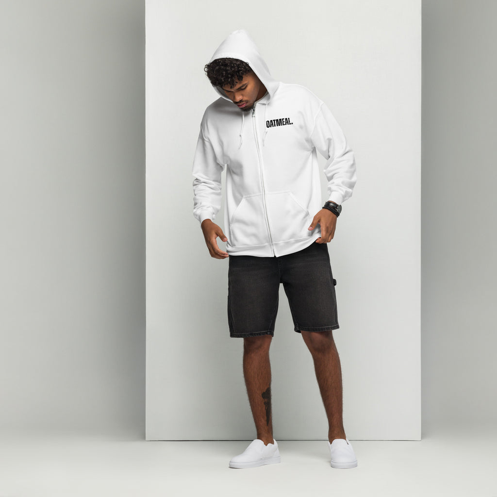 Person wearing a white hoodie with 'oatmeal' branding text, black shorts, and white sneakers on a light gray background exclusively available at Oatmeal Apparel Co.