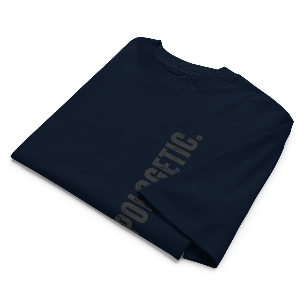 Folded navy blue t-shirt with 'UPAPOLOGETIC' text on a white background at Oatmeal Apparel Co.