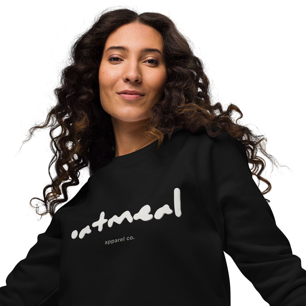 Woman wearing a black sweatshirt with ' oatmeal apparel co.' text on a white background