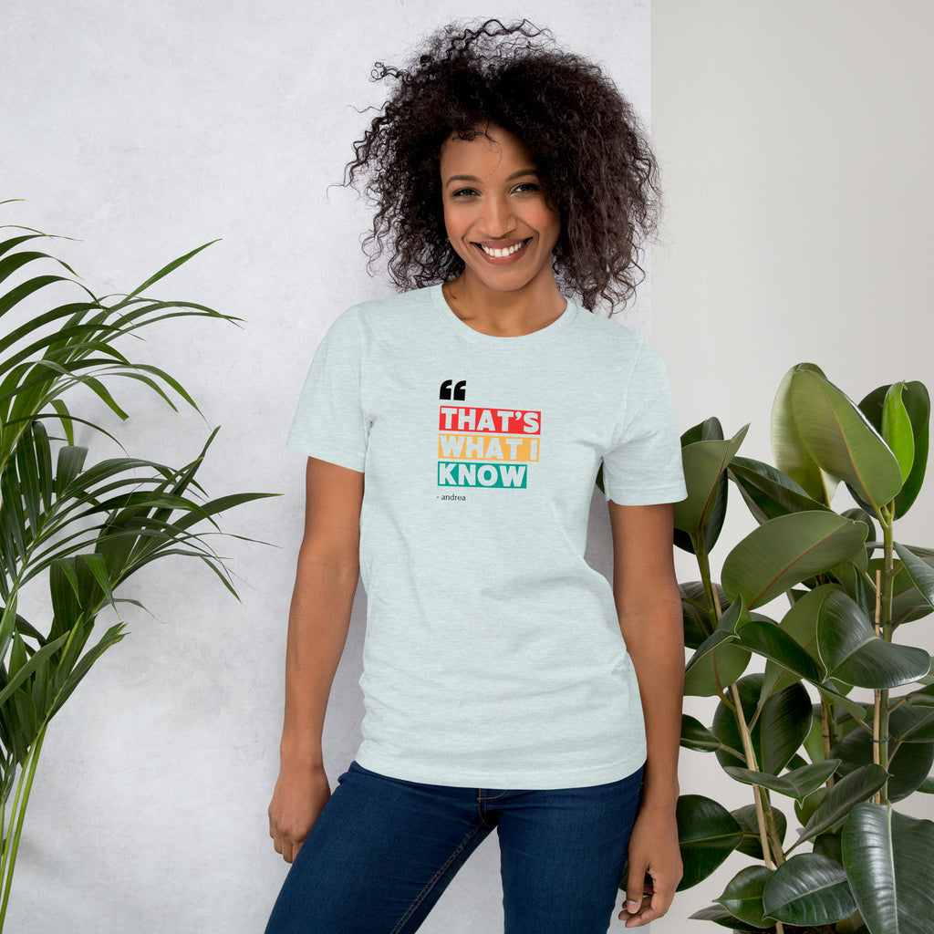 Woman wearing a light blue t-shirt with colorful text design, shirt available at Oatmeal Apparel Co.
