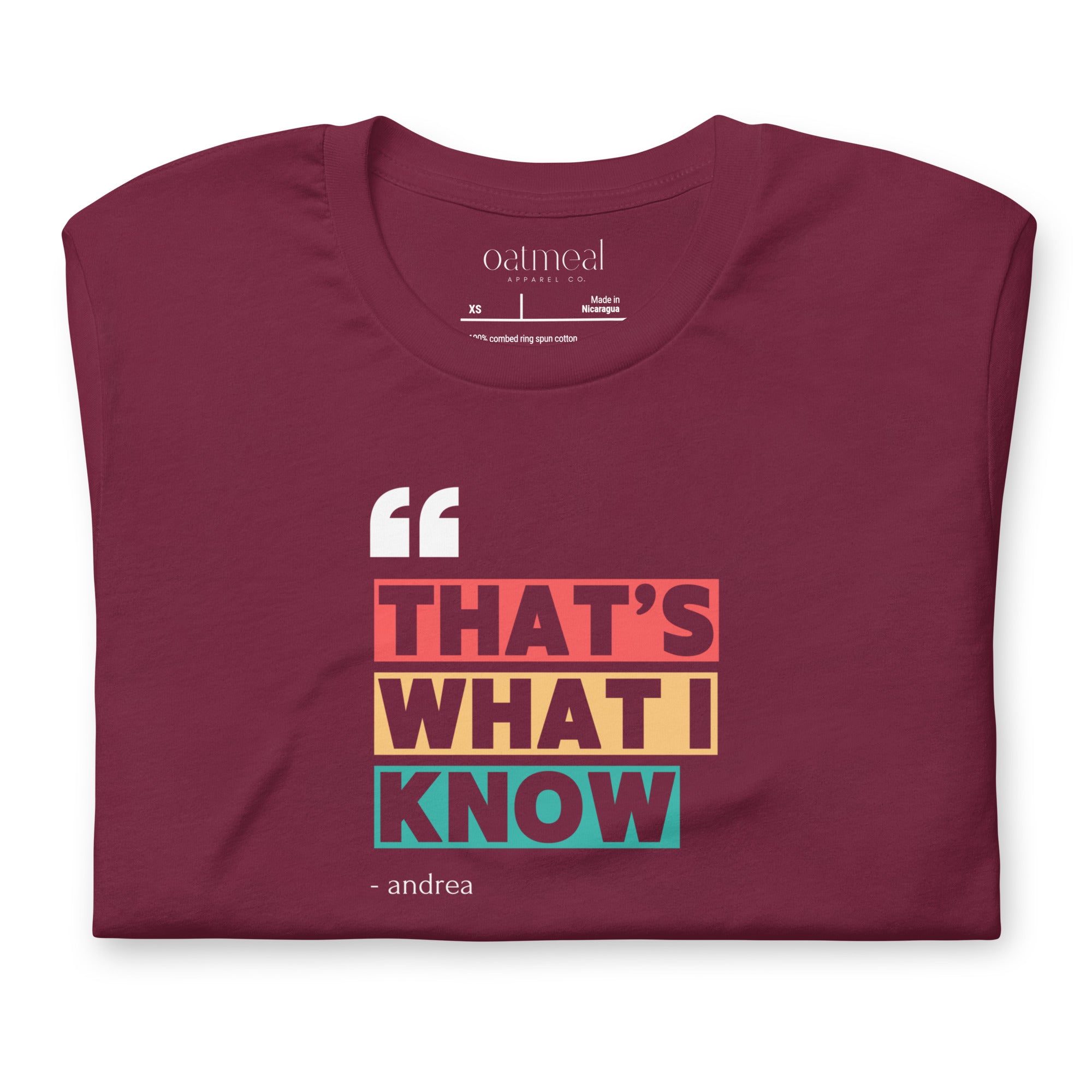 Maroon folded 'That's What I Know' t-shirt with colorful text design on a white background available at Oatmeal Apparel Co.