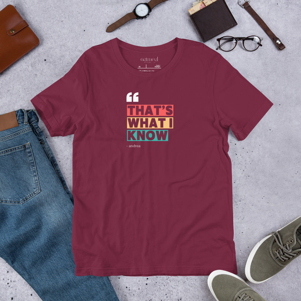 Maroon t-shirt with colorful text design on a gray surface with jeans, shoes, and accessories available at Oatmeal Apparel Co.