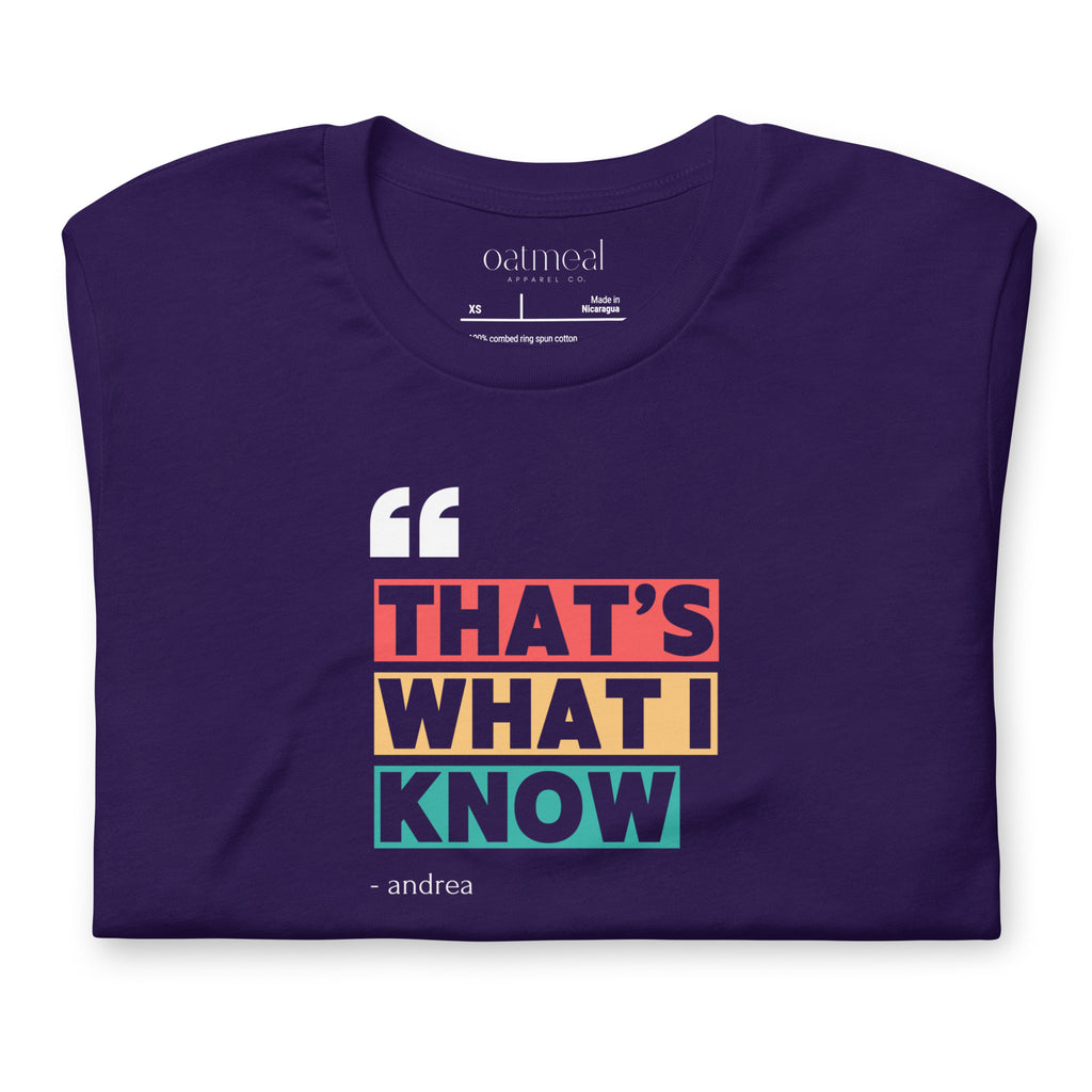 Folded purple t-shirt with colorful text design with 'oatmeal apparel co.' branding label on a white background.