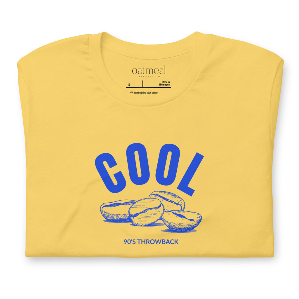 Yellow t-shirt with blue 'COOL Beans' graphic and 'Oatmeal' branding on a white background at Oatmeal Apparel Co.