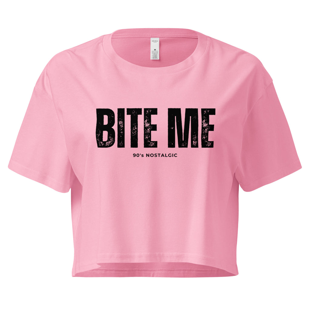 Pink crop top with 'BITE ME 90's NOSTALGIC' text on a white background at Oatmeal Apparel Co.
