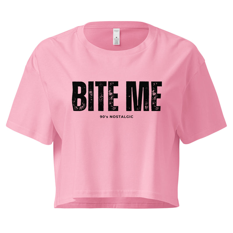 Pink crop top with 'BITE ME 90's NOSTALGIC' text on a white background at Oatmeal Apparel Co.