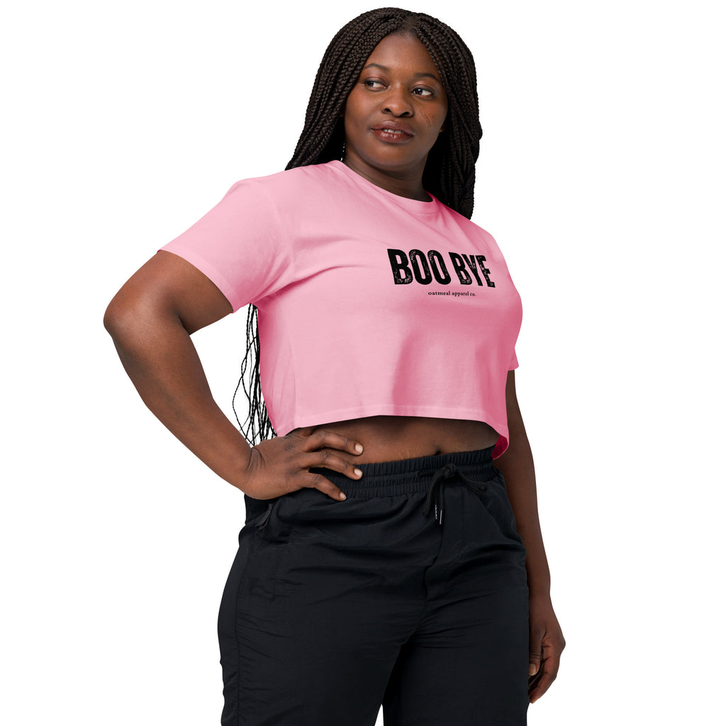 Woman wearing a pink crop top with 'BOO BYE' text on a white background at Oatmeal Apparel Co.