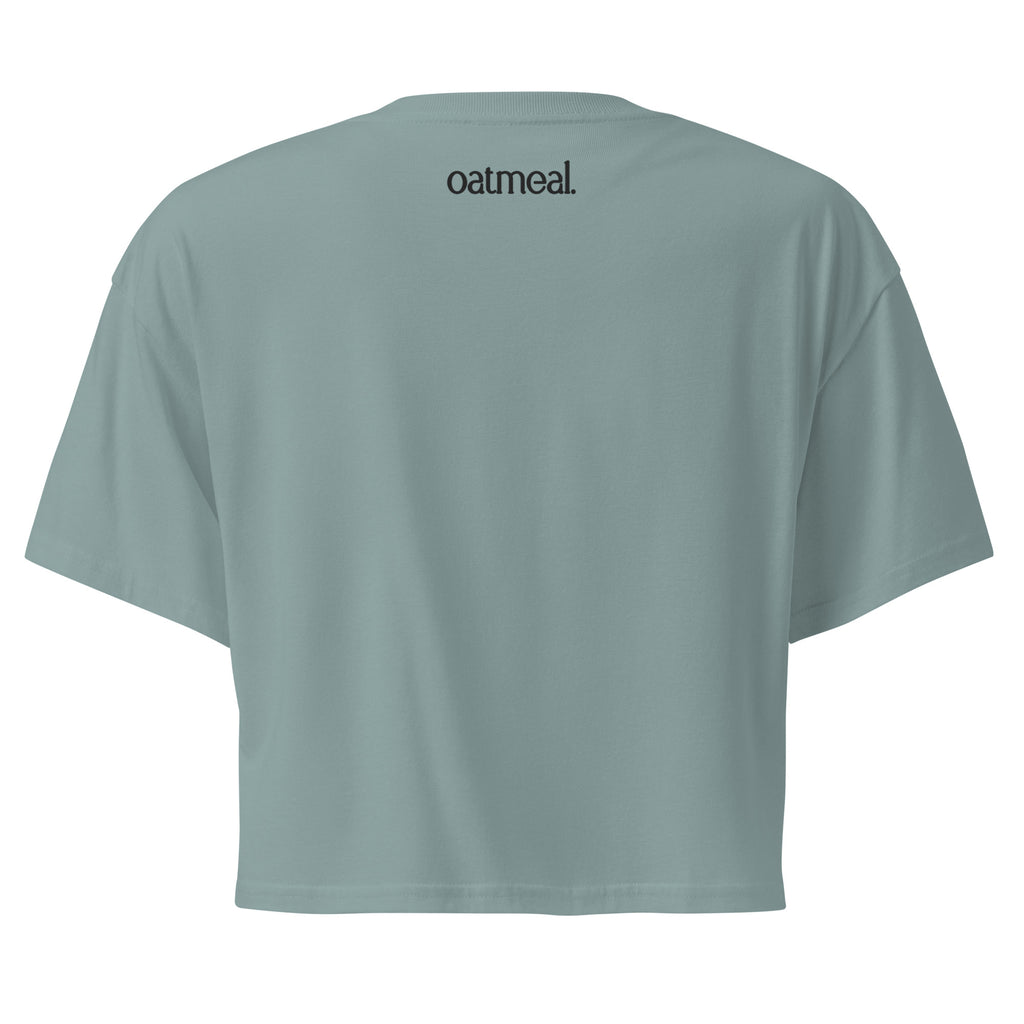 Light gray mineral color crop top with 'oatmeal' branding on the back against a white background at Oatmeal Apparel Co.