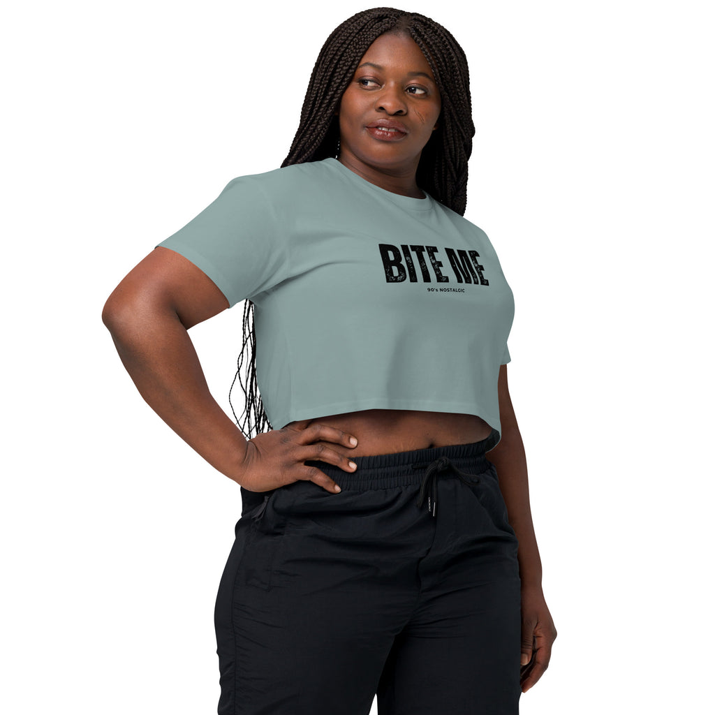 Woman wearing a light blue crop top with 'BITE ME' text on a white background at Oatmeal Apparel Co.