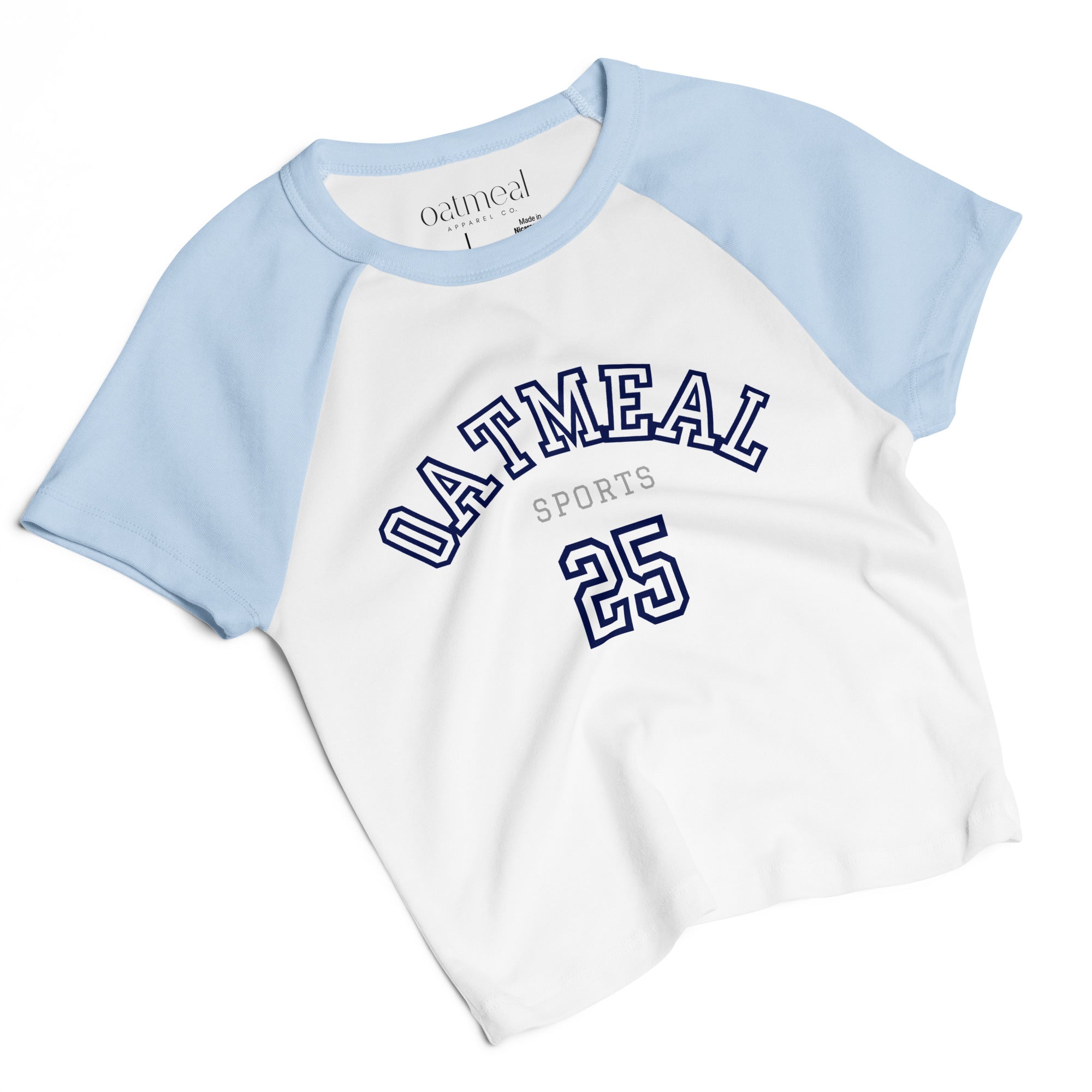 White t-shirt with blue sleeves featuring 'Oatmeal Sports' text on a white background at Oatmeal Apparel Co.