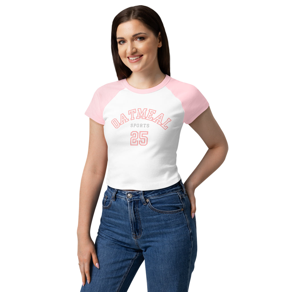 Woman wearing a white t-shirt with pink sleeves and an 'Oatmeal Sports 25' text and graphics at Oatmeal Apparel Co.